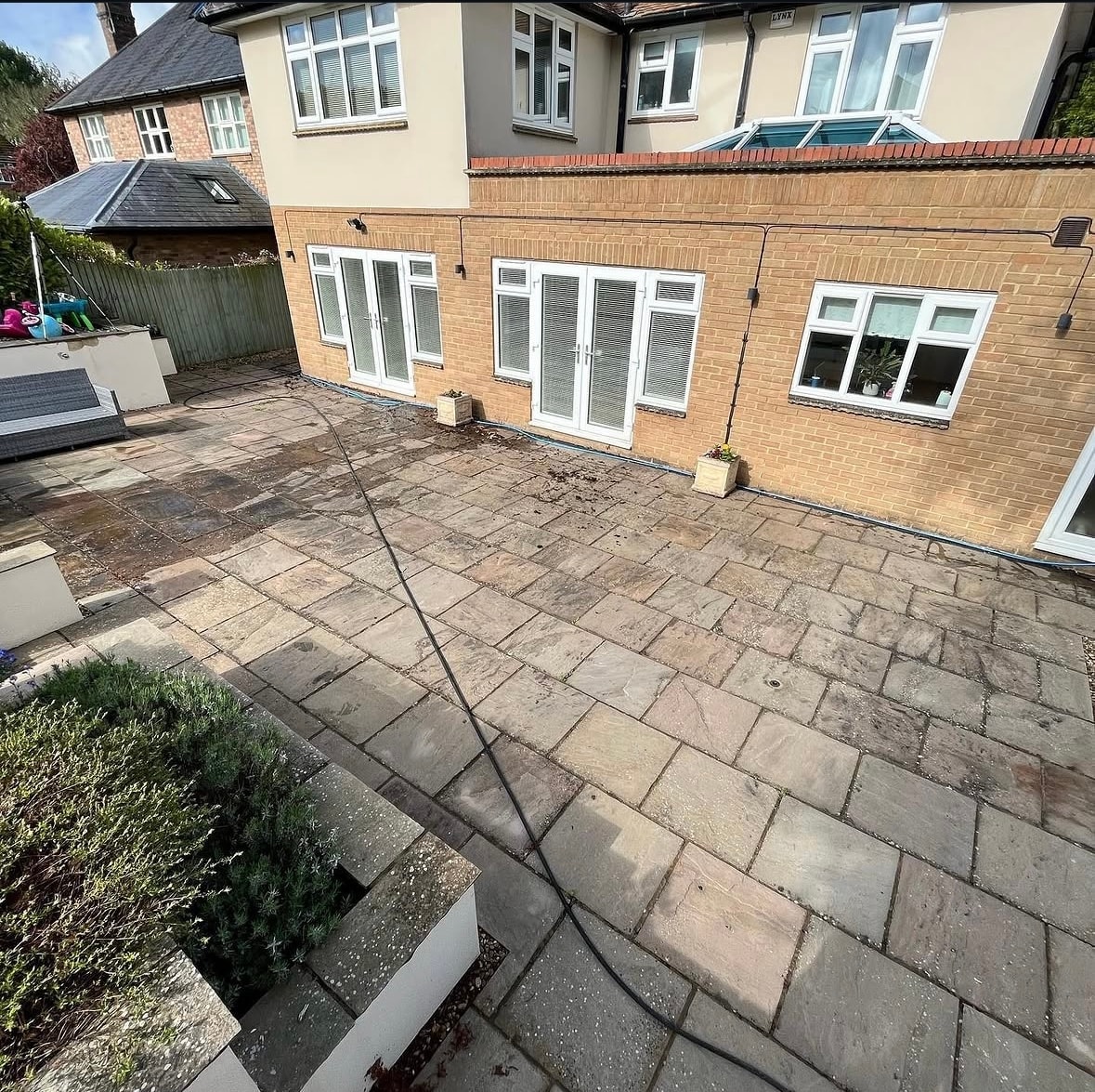 Stained house render before cleaning